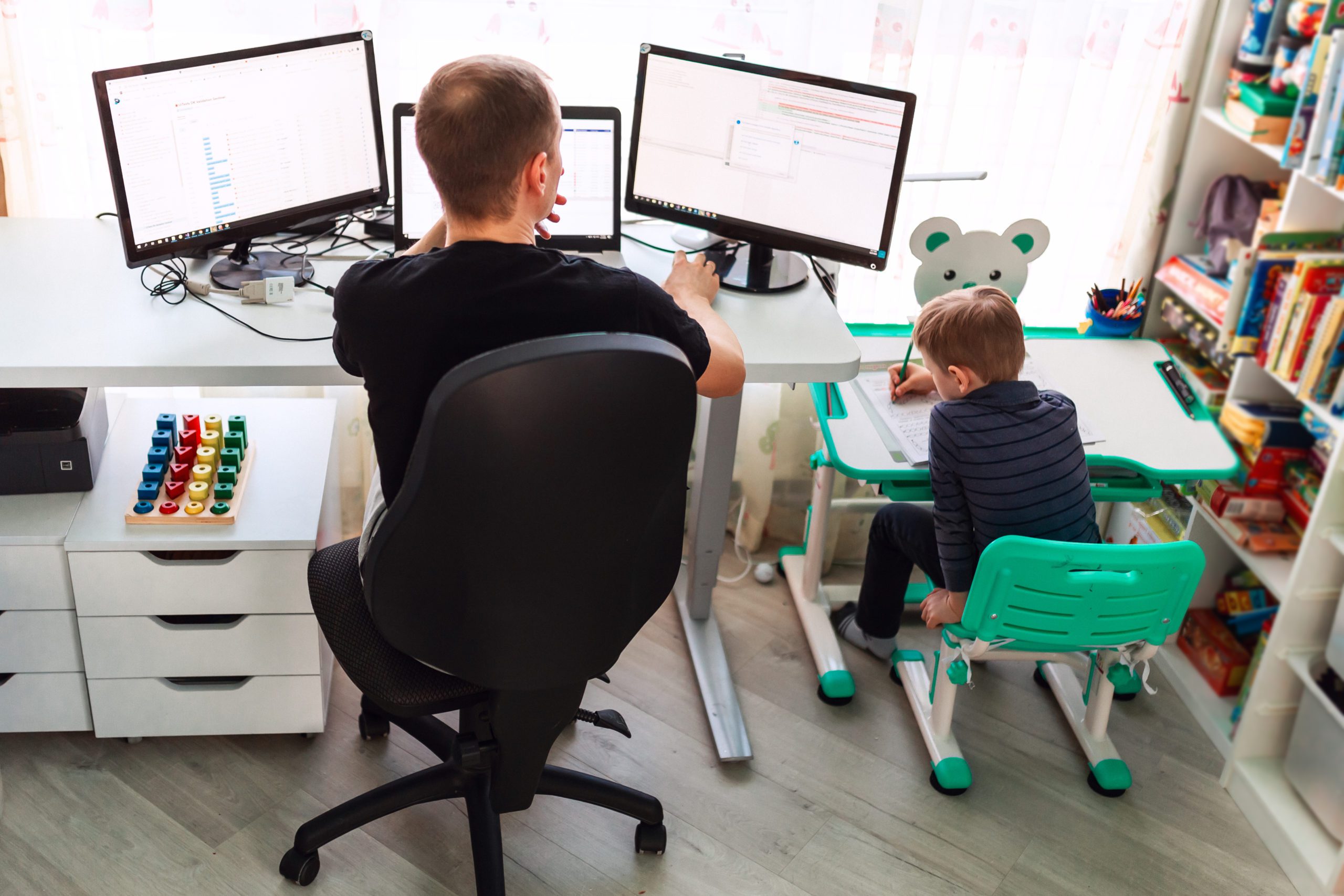 father with kid working from home