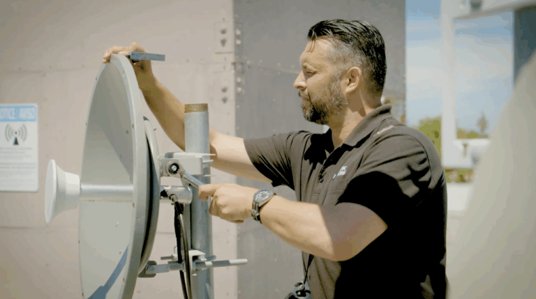 An Etheric Networks field technician/installer configuring an AP radio for Fixed Wireless Access Internet service for a Bay Area business.