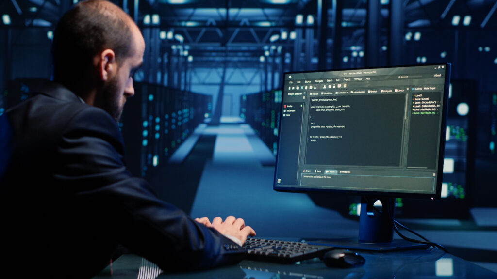 IT engineer monitoring network and cybersecurity systems in a modern data center environment